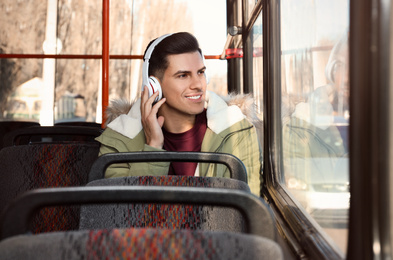 Man listening to audiobook in trolley bus