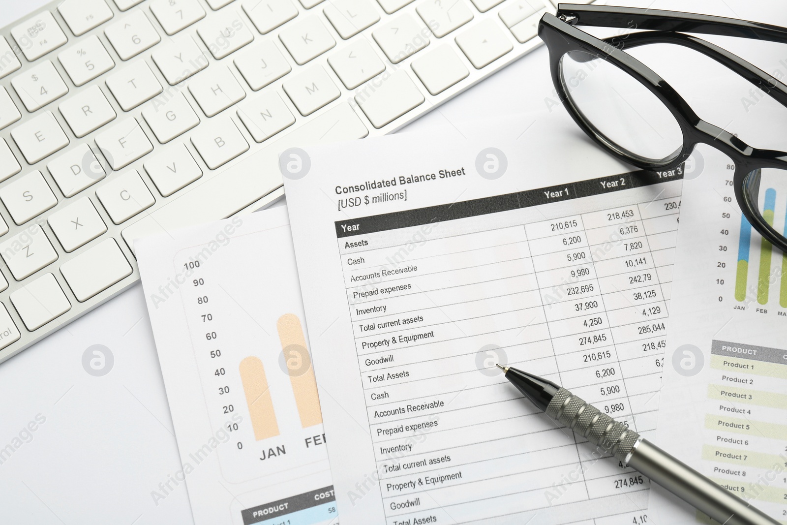 Photo of Accounting documents, pen, glasses and computer keyboard on white table, above view