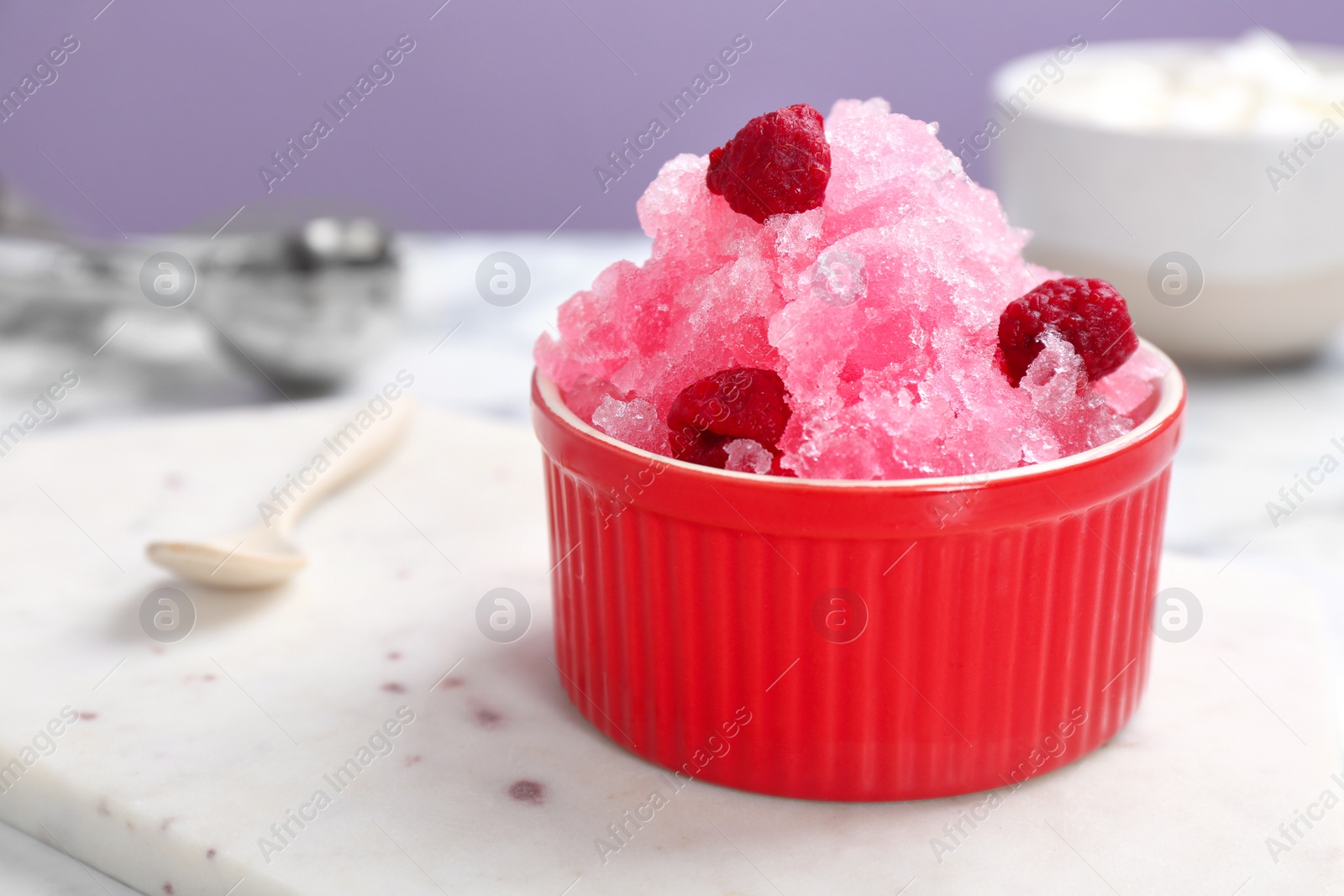 Photo of Bowl of tasty raspberry snow ice cream on board, closeup. Space for text