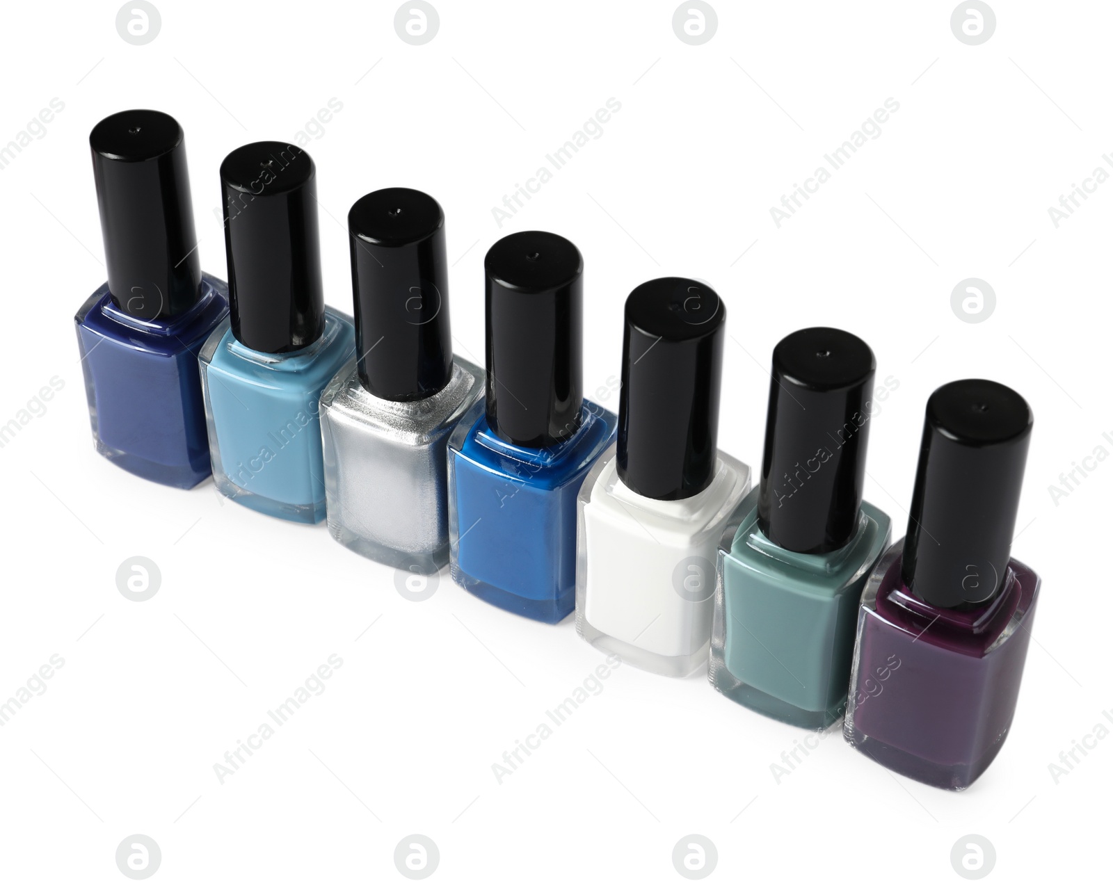 Photo of Bright nail polishes in bottles isolated on white