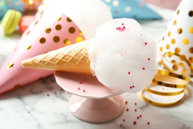 Ice cream cone with cotton candy served on table