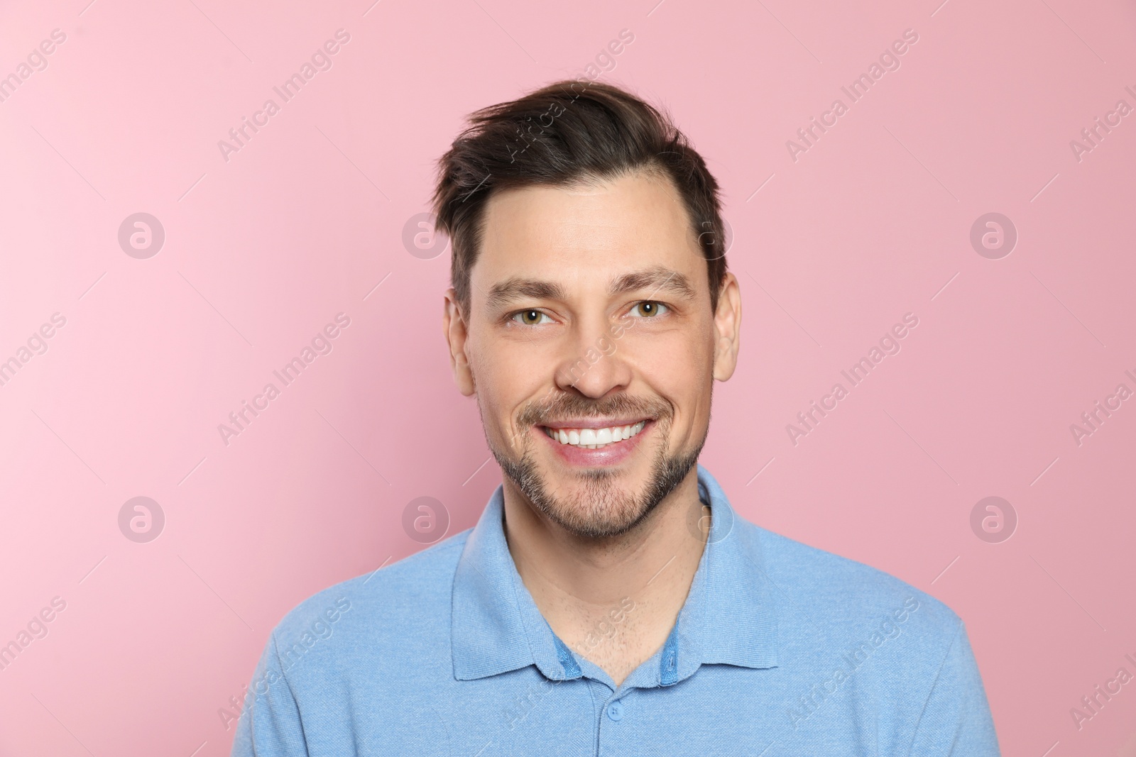 Photo of Smiling man with perfect teeth on color background