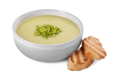 Photo of Bowl of delicious leek soup and croutons isolated on white