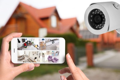 Image of Home security system. Woman monitoring CCTV cameras on smartphone near her house, closeup
