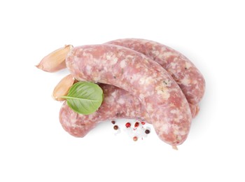 Photo of Raw homemade sausages and different spices isolated on white, top view
