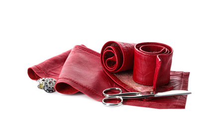 Photo of Red leather samples and craftsman tools isolated on white