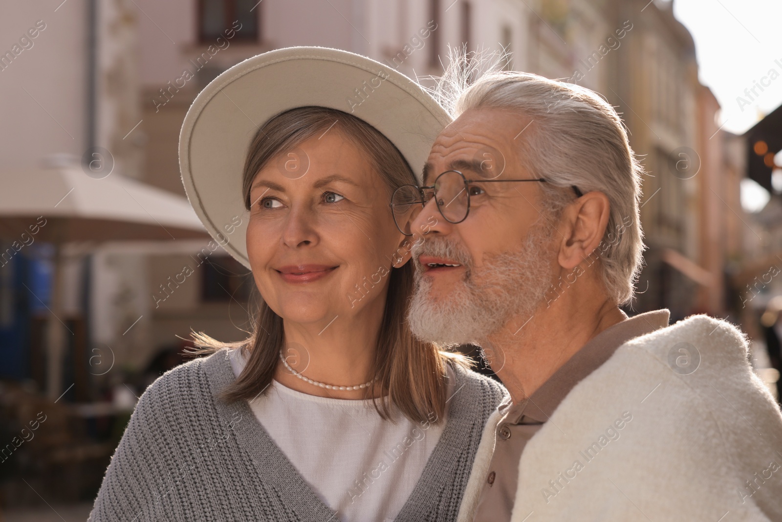 Photo of Portrait of affectionate senior couple walking outdoors