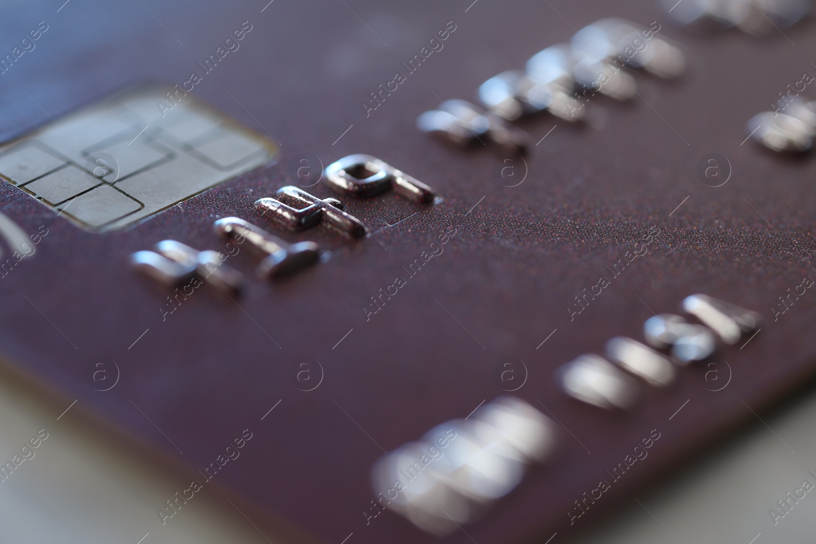 Photo of One credit card on gray background, macro view