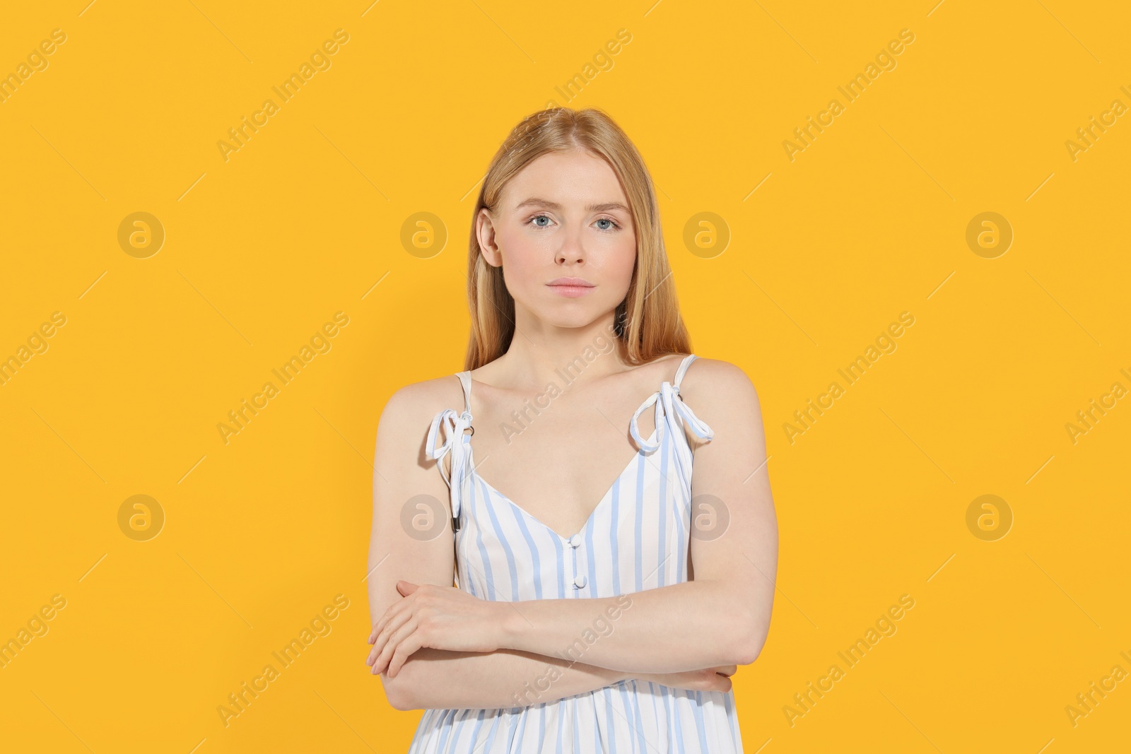 Photo of Beautiful young woman posing on orange background