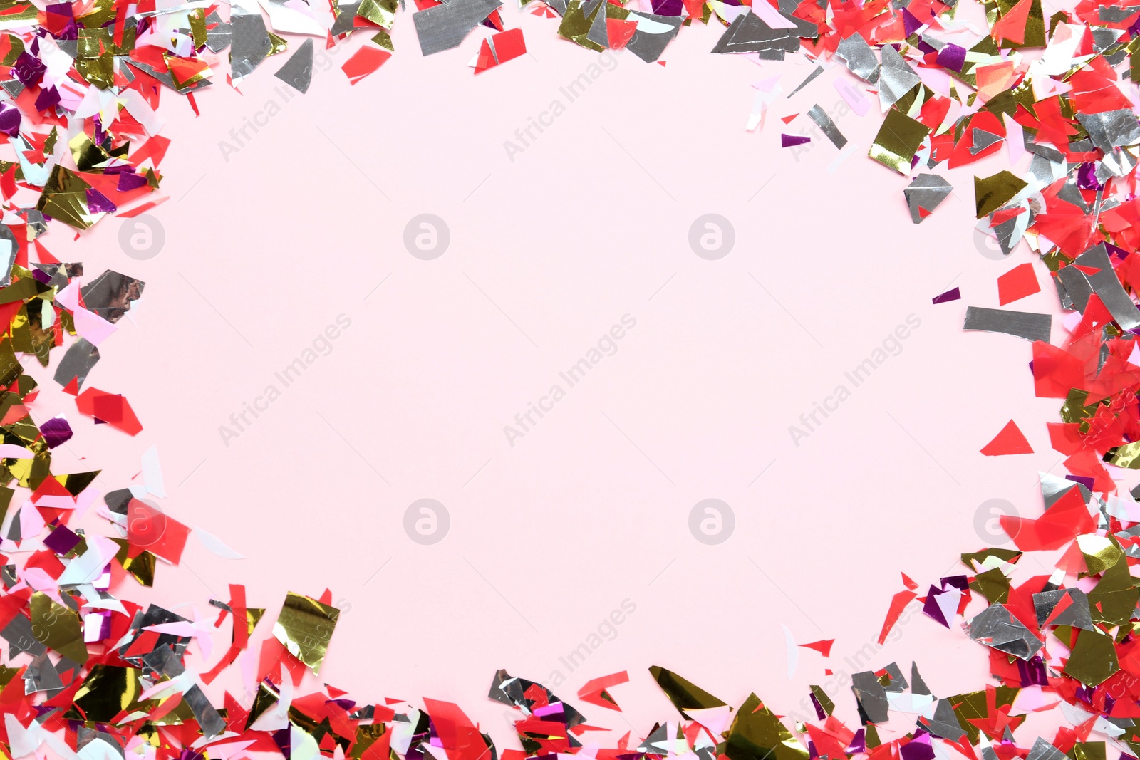 Photo of Frame of shiny colorful confetti on light background, flat lay. Space for text