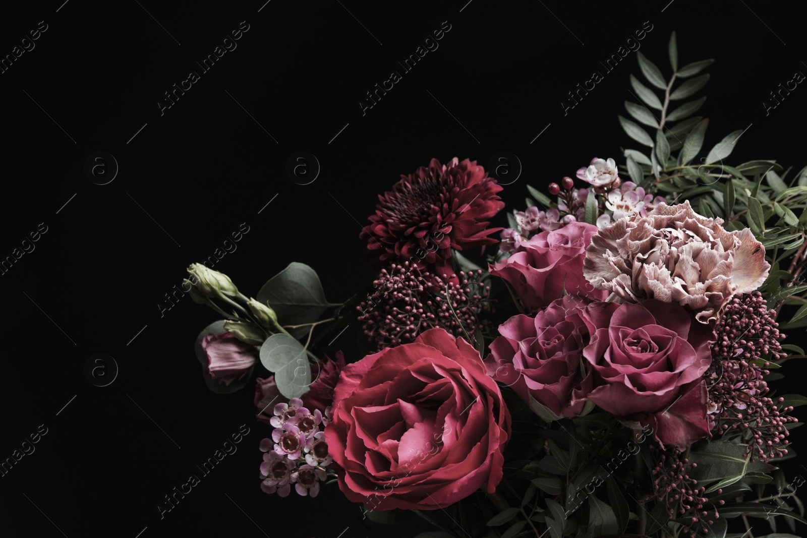 Photo of Beautiful bouquet of different flowers on black background. Floral card design with dark vintage effect