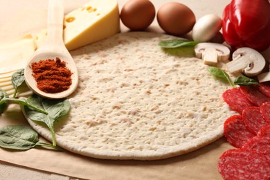 Photo of Pizza base and products on table, closeup