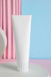 Photo of Blank tube of toothpaste on color background