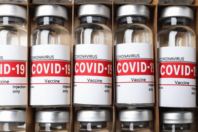 Glass vials with COVID-19 vaccine in package, top view