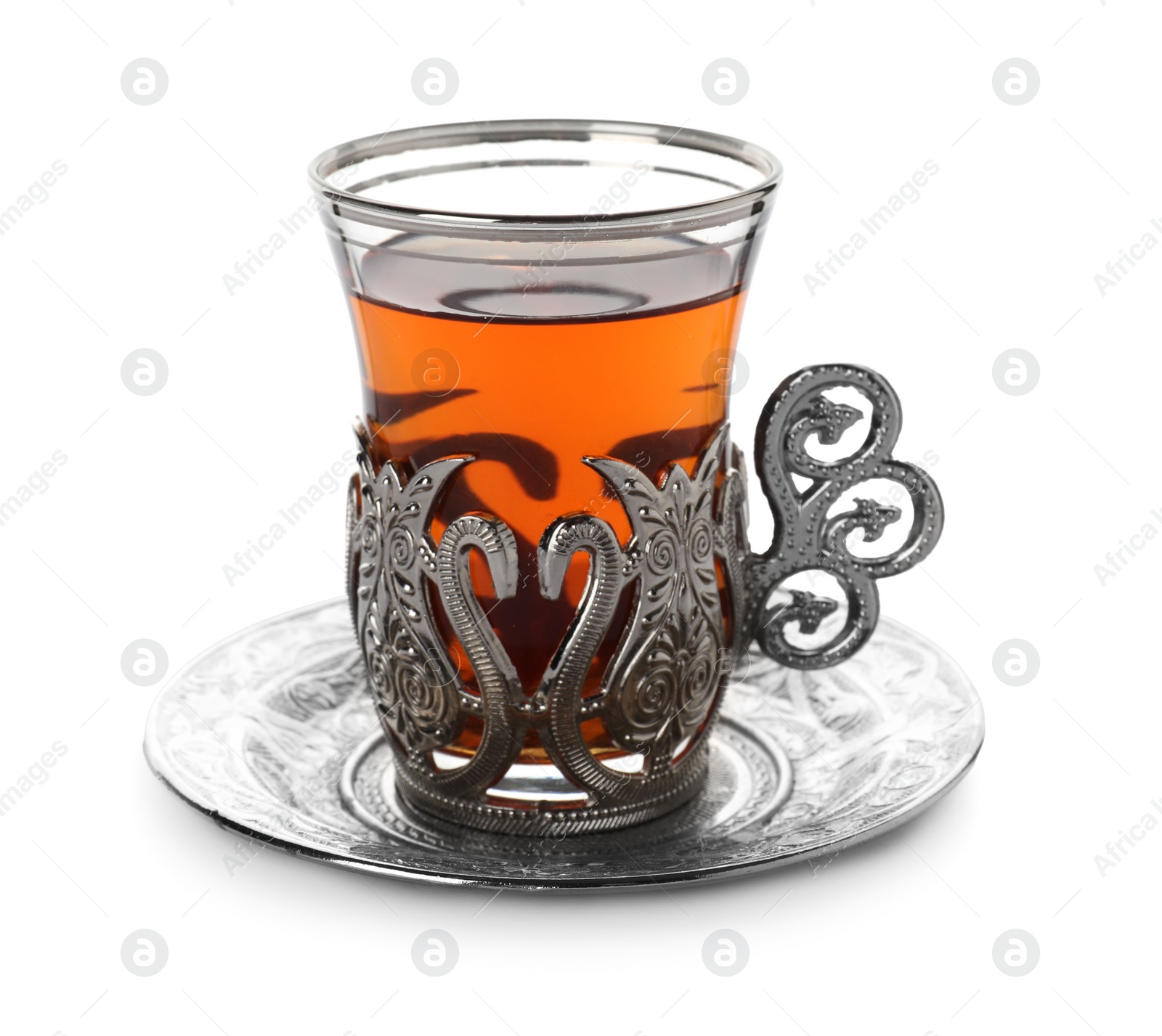 Photo of Glass of traditional Turkish tea in vintage holder isolated on white