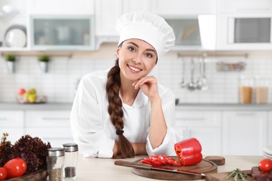 Photo of Professional female chef in uniform at restaurant kitchen