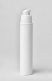 Photo of Bottle of cosmetic product on light background