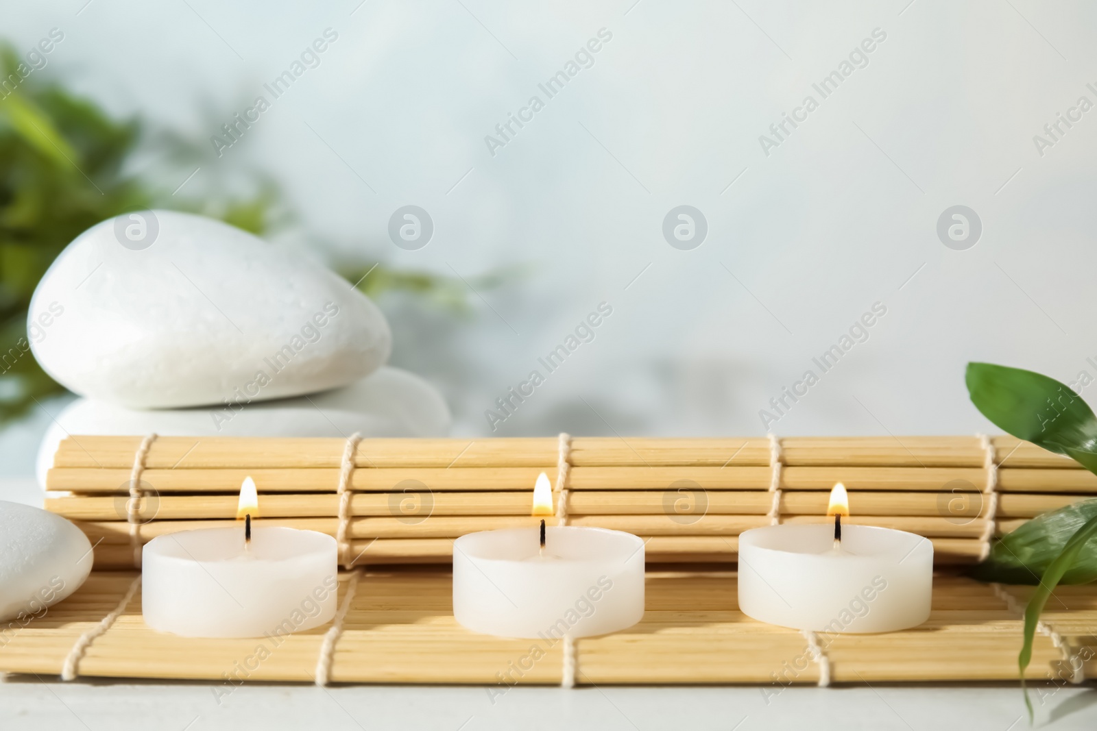 Photo of Spa composition with burning candles on table