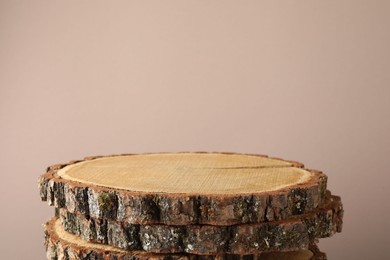 Photo of Presentation for product. Wooden stumps on beige background. Space for text