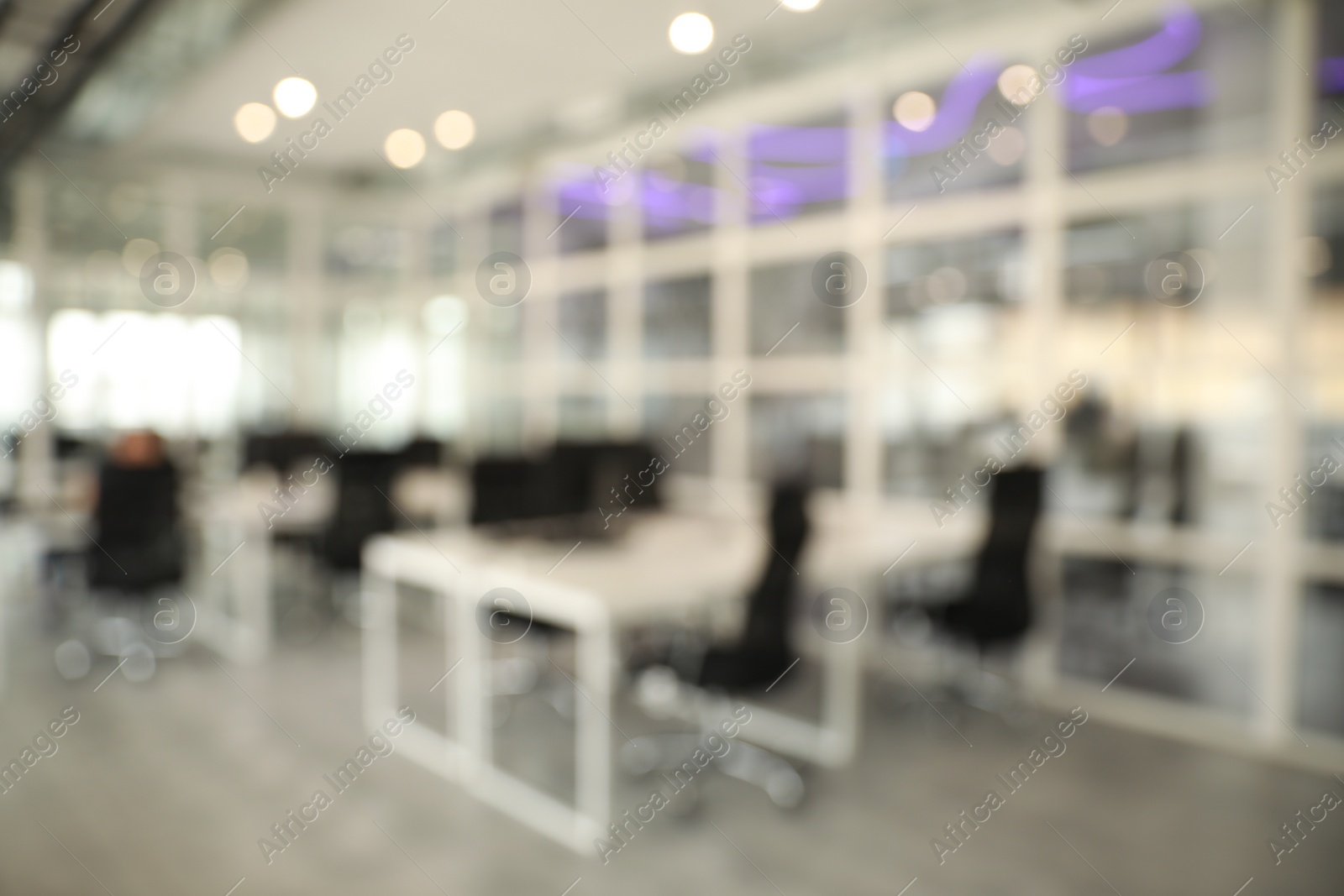 Photo of Blurred view of cozy workspaces with tables and chairs in office