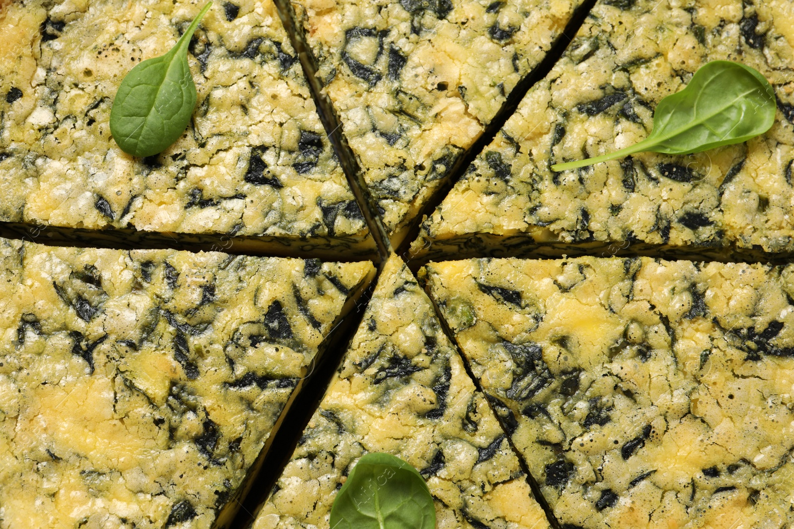 Photo of Closeup view of cut delicious spinach pie