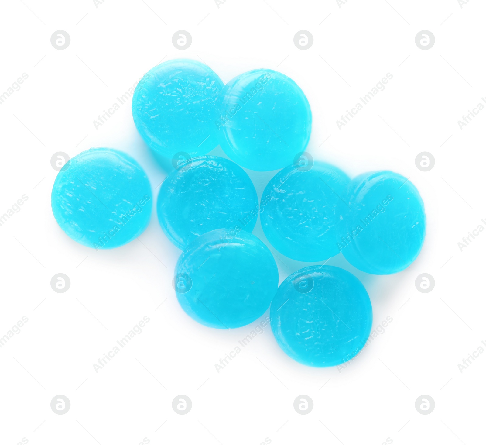 Photo of Many light blue cough drops on white background, top view