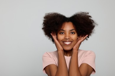 Photo of Portrait of smiling African American woman on light grey background. Space for text