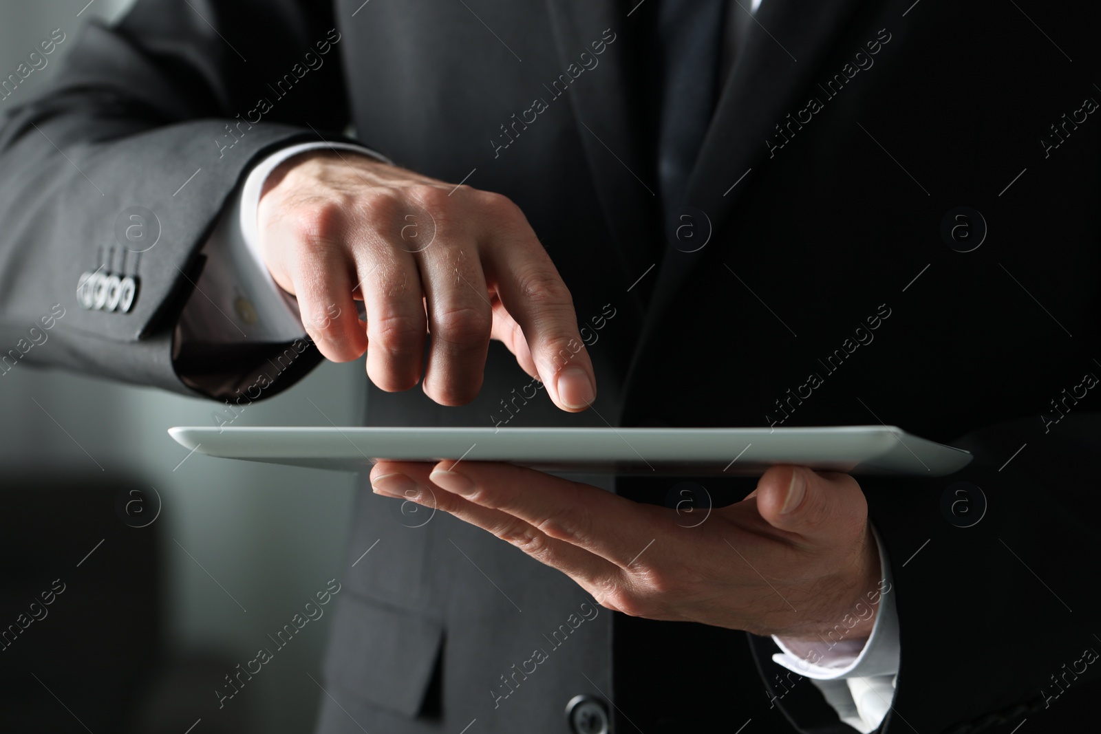 Photo of Closeup view of man using new tablet indoors