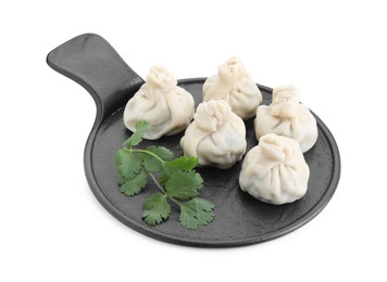 Photo of Serving board with tasty fresh khinkali (dumplings) and parsley isolated on white. Georgian cuisine