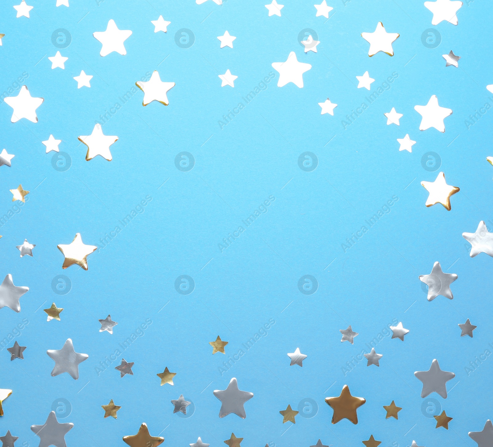 Photo of Frame made of confetti stars with space for text on blue background, top view. Christmas celebration