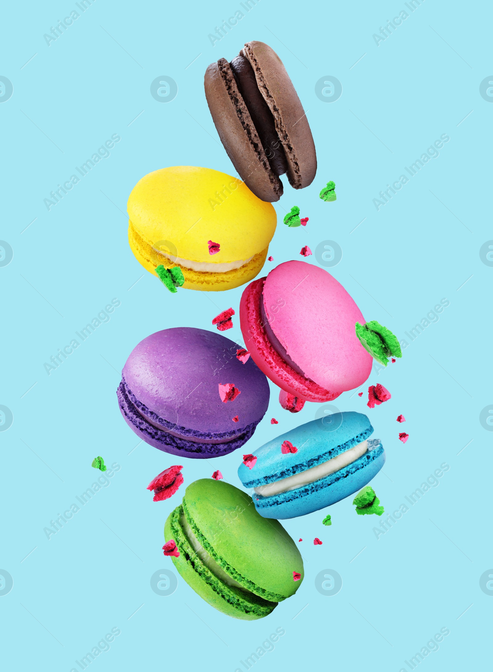 Image of Sweet delicious macarons flying on light blue background