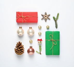 Flat lay composition with Christmas gifts and festive decor on white background