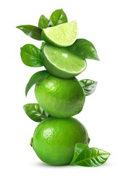 Image of Stacked cut and whole limes with green leaves on white background