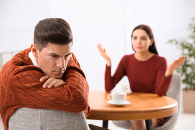 Unhappy man after quarrel with his girlfriend indoors. Relationship problems