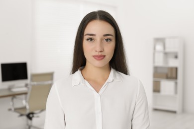 Photo of Portrait of beautiful young woman in office