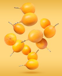 Image of Delicious ripe granadillas falling on orange background