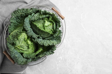 Fresh green savoy cabbages on marble table, top view. Space for text