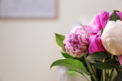 Photo of Bouquet of beautiful peonies in room, closeup. Space for text