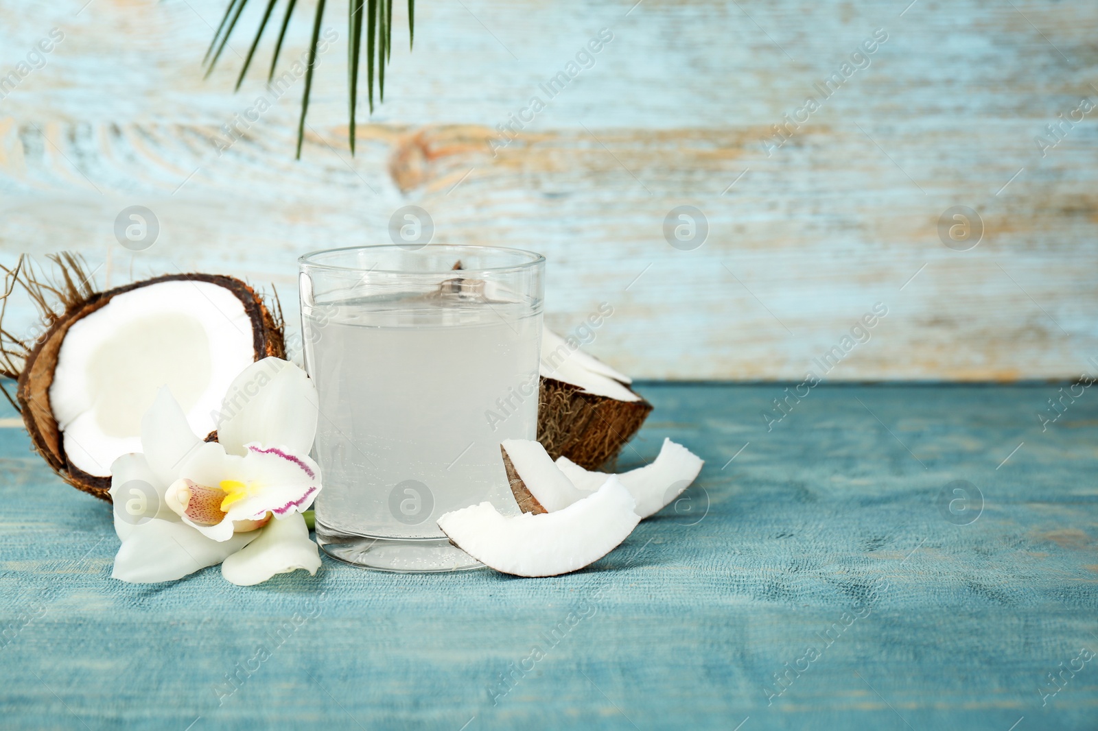 Photo of Glass of coconut water on wooden table
