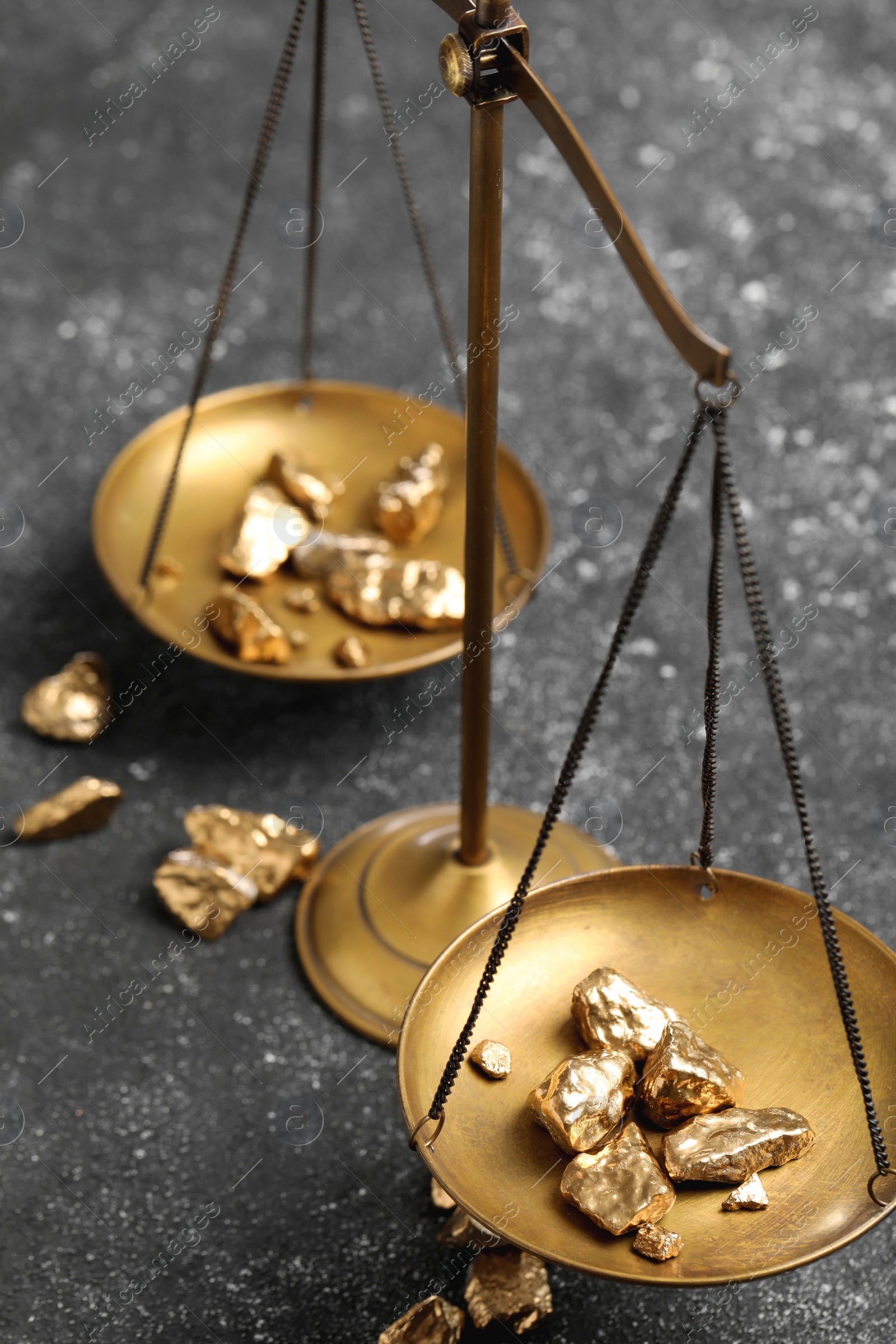 Photo of Vintage scales with gold nuggets on grey table