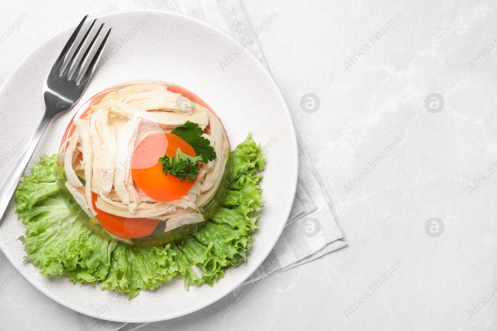 Photo of Delicious chicken aspic served on light table, top view. Space for text