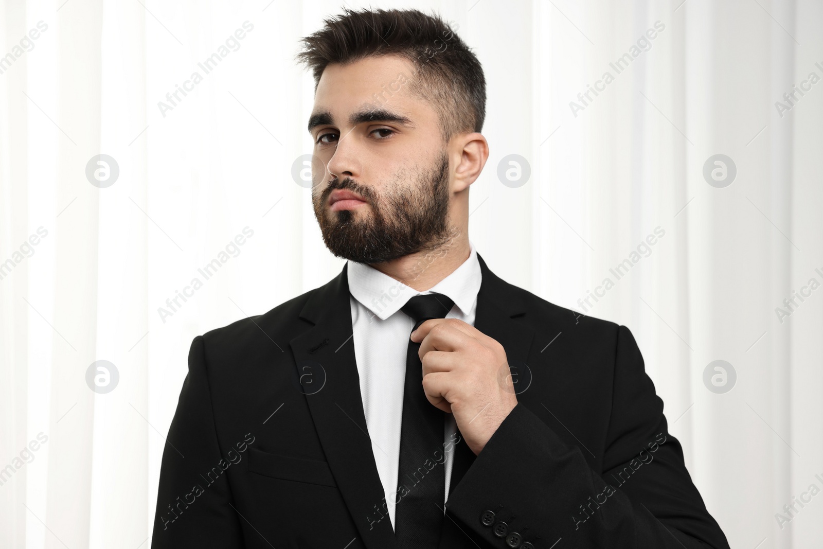 Photo of Handsome businessman in suit and necktie indoors