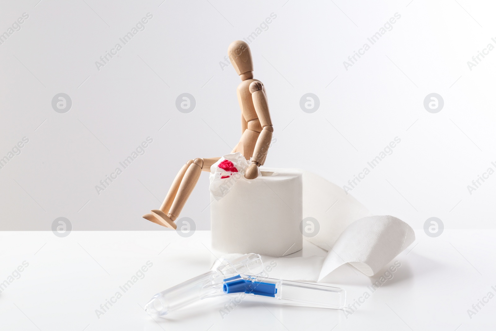 Photo of Composition with anoscope on white background. Hemorrhoid treatment