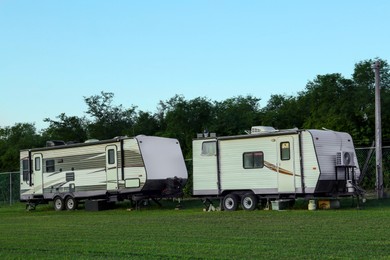 Photo of Travel trailers parked outdoors. Home on wheels