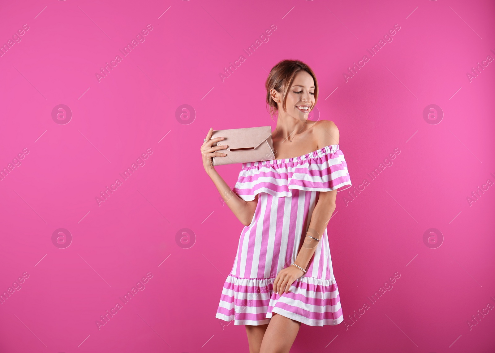 Photo of Portrait of young woman in stylish outfit with purse on color background