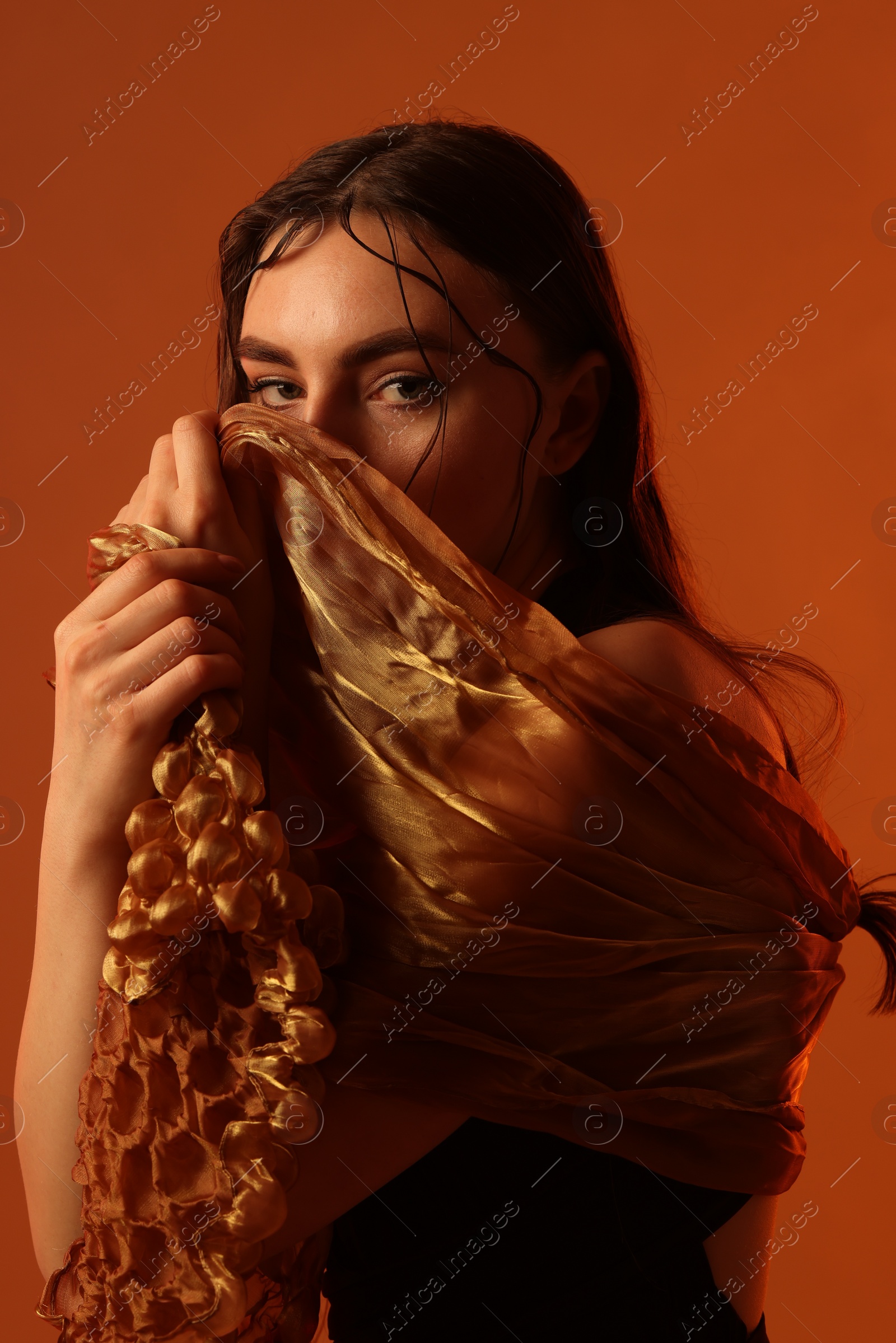 Photo of Fashionable portrait of beautiful woman on brown background