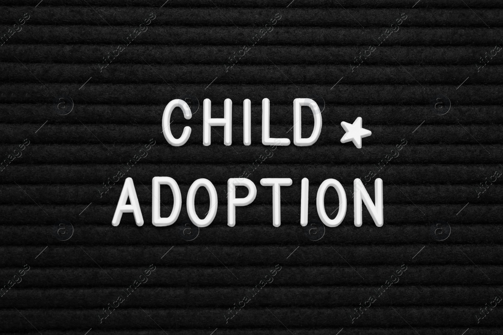 Photo of Phrase Child Adoption on black letter board, flat lay