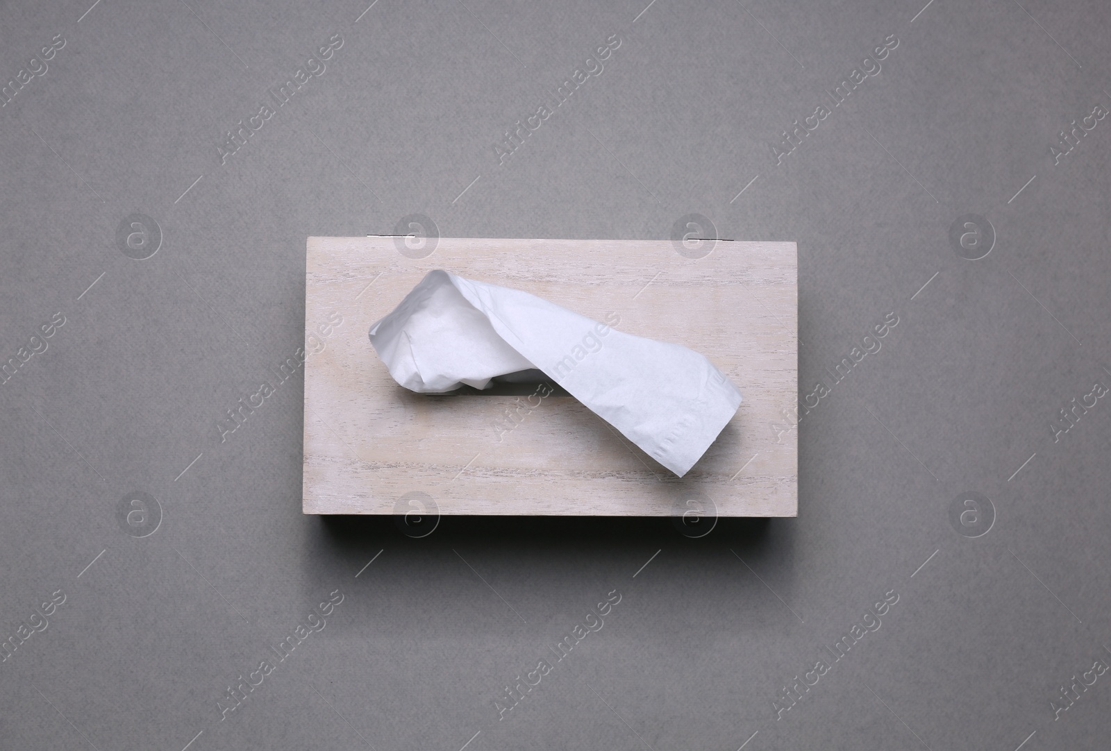 Photo of Holder with paper tissues on grey background, top view