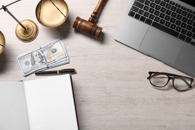 Tax law. Flat lay composition with open book and gavel on wooden table, space for text