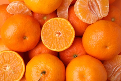 Heap of fresh juicy tangerines as background, top view